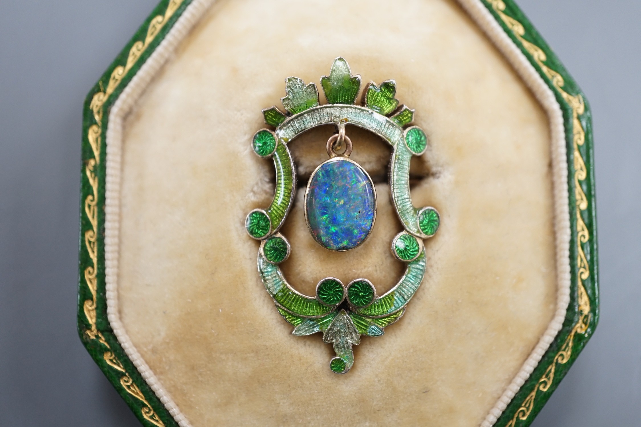A late Victorian Child & Child yellow metal, green enamel and drop black opal set brooch, 35mm, gross weight 6.4 grams, in fitted Child & Child gilt tooled leather case.